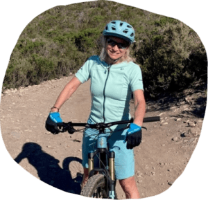 Lynn Renshaw smiling on a mountain bike on a California Trail