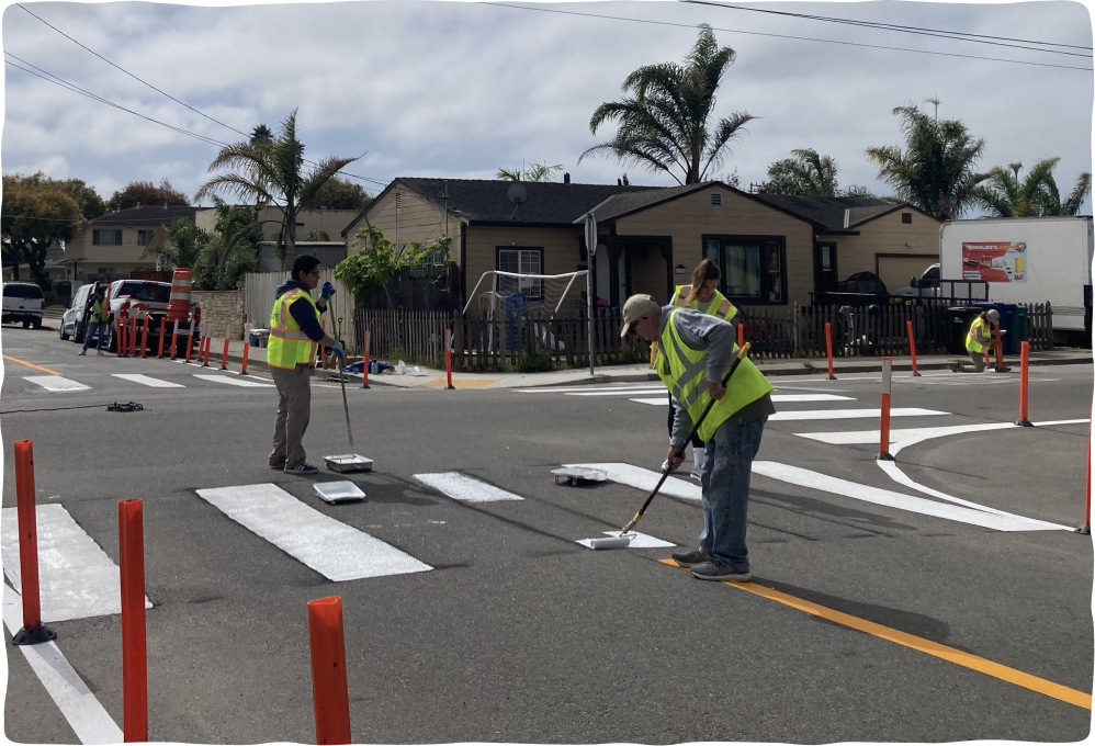 Team painting temporary crosswalk for the installation